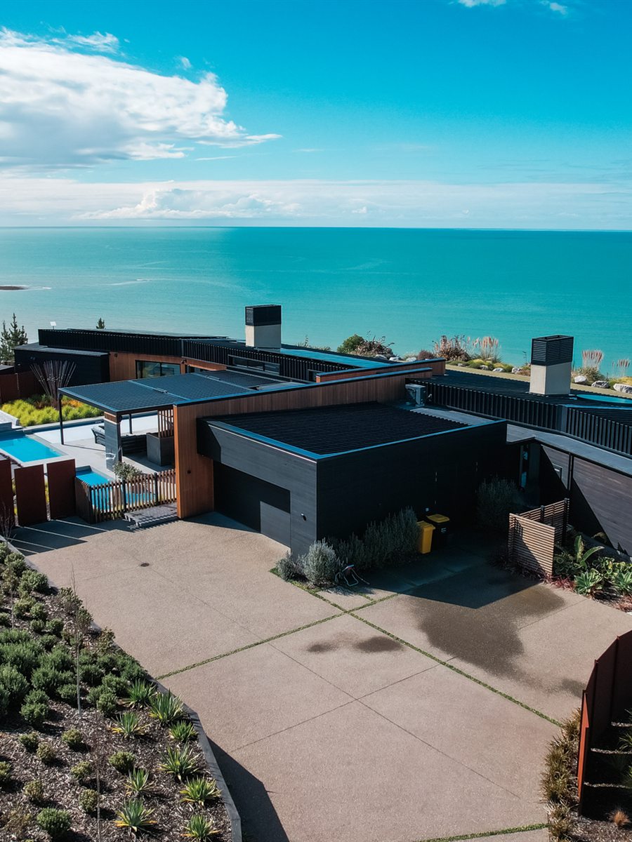 Clifftop house and pool above the sea at Tasman, photographed from the air