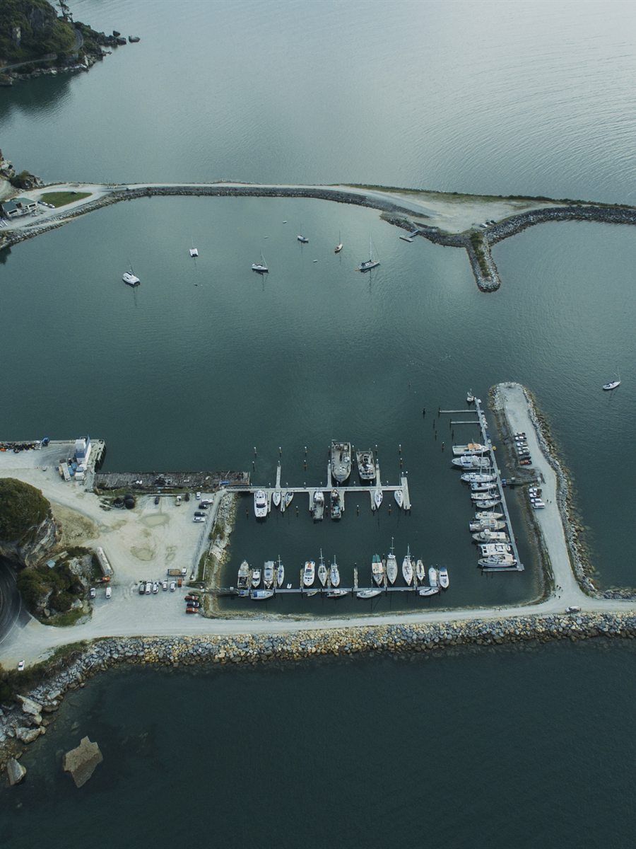 Marina, breakwater and moored boats seen from directly overhead